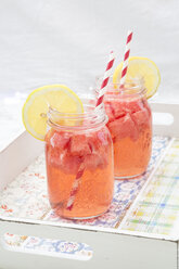 Two glasses of homemade watermelon lemonade on a tray - LVF003734