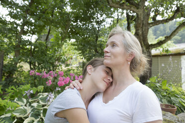 Mother and daughter hugging - SGF001790