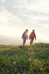 Österreich, Tirol, Paar wandert am Unterberghorn bei Sonnenaufgang - RBF002965