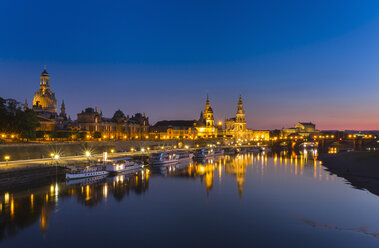 Germany, Saxony, Dresden, Lighted historic old town with Elbe River in the foreground at night - HSIF000360