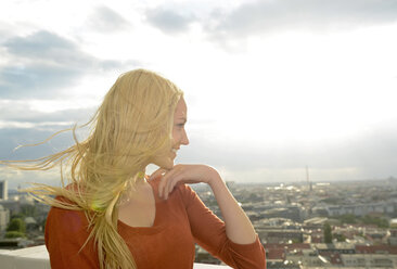 Germany, Berlin, young woman with blowing hair looking at view - BFRF001405