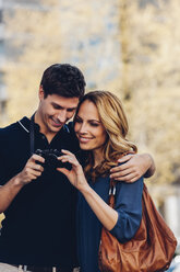 Smiling couple outdoors looking at camera - CHAF000936