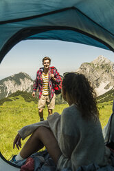 Austria, Tyrol, Tannheimer Tal, young couple camping on alpine meadow - UUF005061