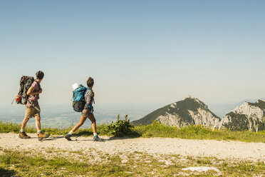 Austria, Tyrol, Tannheimer Tal, young couple hiking on mountain trail - UUF005087