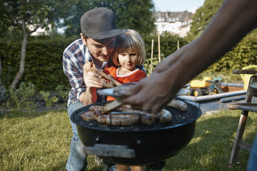 Family having a barbecue in garden - RHF001022