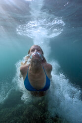 Bali, Indonesia, Female jumping in the sea - TOVF000001