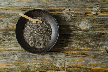 Chia seeds with a wooden spoon in a bowl - ODF001156