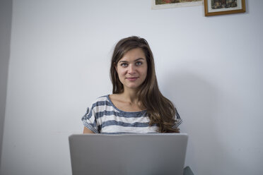 Young woman at home using laptop - RIBF000239