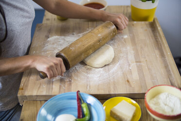 Young woman preparing pizza dough in kitchen - RIBF000189