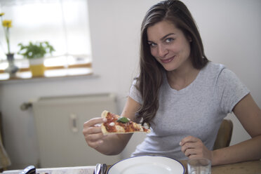 Junge Frau isst hausgemachte Pizza - RIBF000208