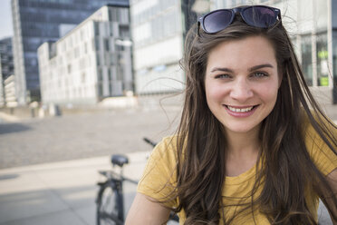 Germany, Cologne, portrait of smiling young woman - RIBF000211