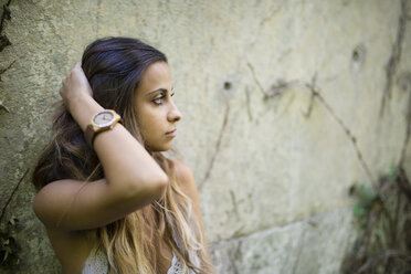Young woman with hand in hair looking sideways - RAEF000255