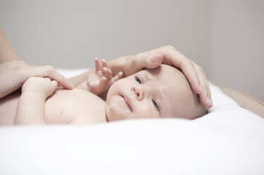 Portrait of baby lying on changing table - MFRF000290