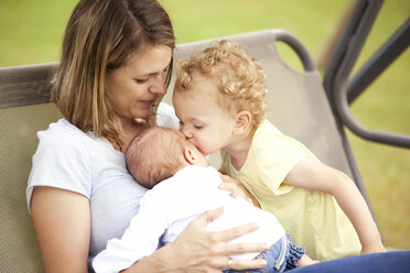 Young mother with her two little daughters on a canopy swing - MFRF000327