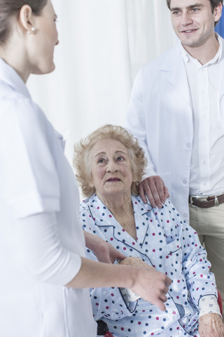 Doctor and nurse with elderly patient stock photo