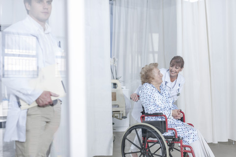 Doctor and elderly patient in wheelchair stock photo