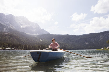 Germany, Bavaria, Eibsee, man in rowing boat on the lake - RBF003011