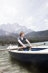 Germany, Bavaria, Eibsee, man in rowing boat on the lake - RBF003042