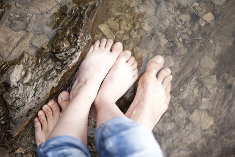 Close-up of father with daughter standing in water of a lake stock photo