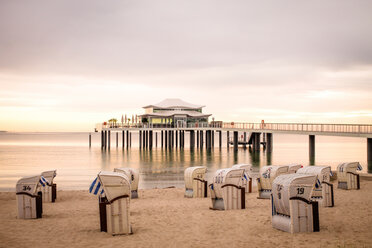 Germany, Niendorf, view to Timmendorfer Strand with hooded beach chairs and sea bridge - PUF000407