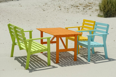 Corsica, Calvi, colorful tables and benches at beach - LBF001154