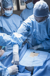 Surgical team preparing patient for operation - ZEF007369