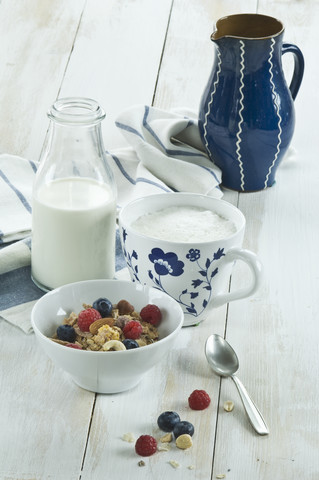 Breakfast with muesli and fruits, cappuchino and bottle of milk stock photo