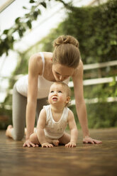 Woman kissing her little daughter - ABF000635