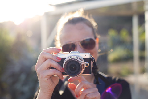 Woman holding camera stock photo