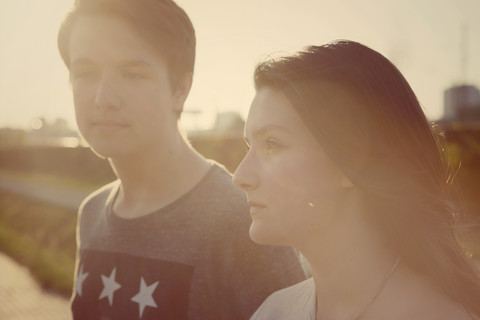 Portrait of teenage couple at backlight stock photo