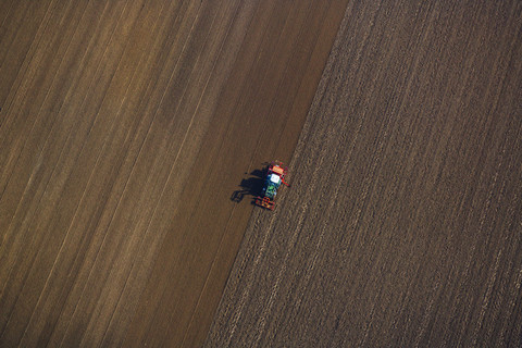 Tractor on field, aerial view stock photo