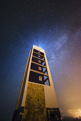 Spain, Valdovino, starry sky over lighthouse at night - RAEF000273