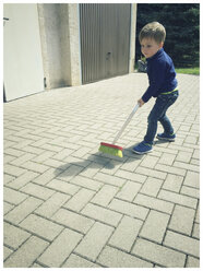 Toddler boy with broom - ABAF001853