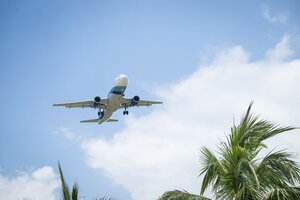 Passenger plane approaching at tropic destination - ABAF001871