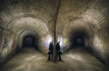 Spain, man leaning on wall in a tunnel, montage - RAEF000275