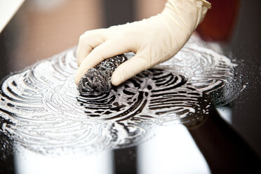 Frau beim Reinigen eines Glaskeramik-Kochfeldes - MFRF000371