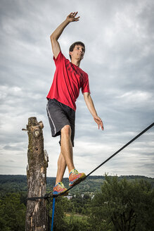 Young man balancing on slackline - STSF000853