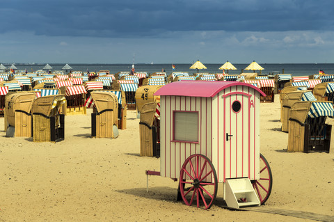 Germany, Schleswig-Holstein, Travemuende, roofed wicker beach chairs and changing cubicle stock photo