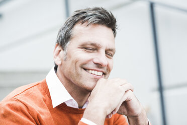 Businessman wearing orange sweater, portrait - UUF005239