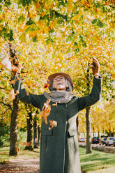 Woman throwing autum leaves in the air - CHAF001117