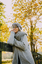 Portrait of woman wearing grey knitwear in an autumnal park - CHAF001127