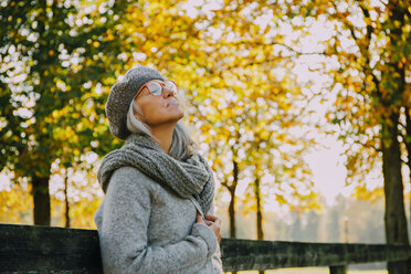 Woman wwith closed eyes in an autumnal park - CHAF001128
