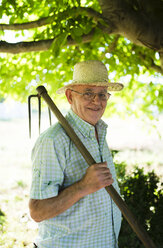 Spain, Ferrol, portrait of a farmer with hatchet on his shoulder - RAEF000279