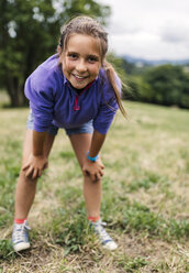 Portrait of girl standing on a meadow looking at viewer - MGOF000415