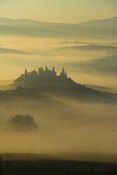 Italy, Tuscany, San Quirico d'Orcia, view to rolling landscape at sunrise in the fog - LOMF000040