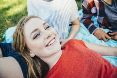 Three teenage friends relaxing in meadow - AIF000080