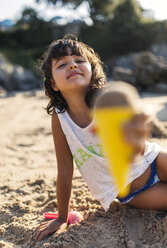 Spain, Llanes, little girl playing with sand on the beach - MGOF000428