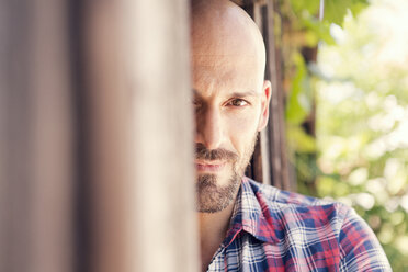 Portrait of bald man wearing checked shirt - MAEF010934