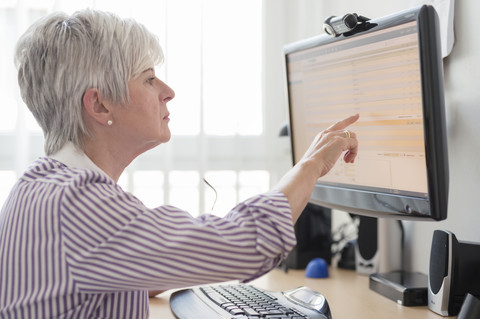 Senior woman online banking stock photo