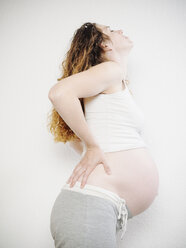 Pregnant woman holding her back - KRPF001618